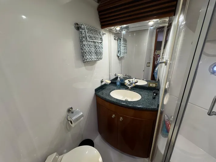  Yacht Photos Pics Bathroom interior of 2000 Carver 450 Voyager Pilothouse with dual sinks and modern fixtures.