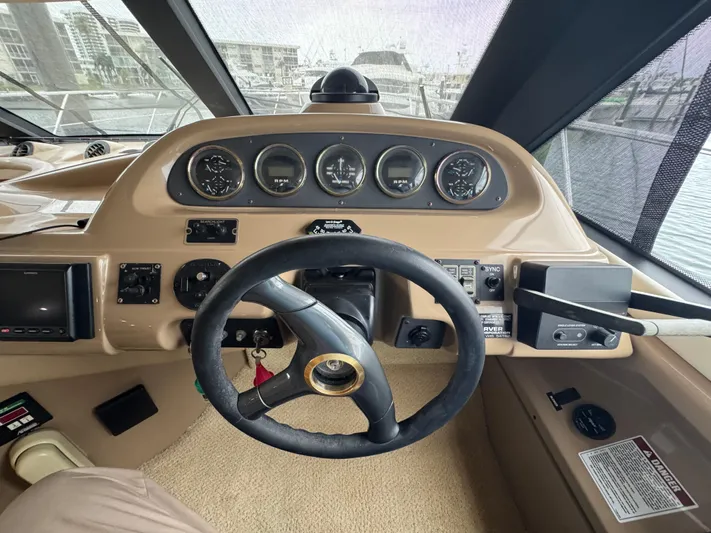  Yacht Photos Pics Pilothouse of 2000 Carver 450 Voyager with steering wheel and instrument panel.