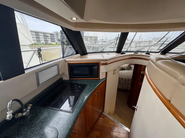  Yacht Photos Pics Interior of 2000 Carver 450 Voyager Pilothouse with kitchen and seating area.