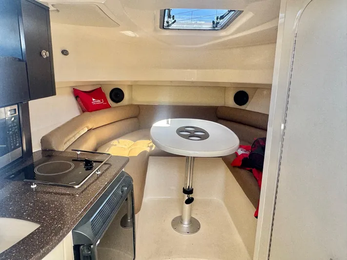  Yacht Photos Pics Interior of 2008 Boston Whaler 285 Conquest boat with seating and kitchenette.