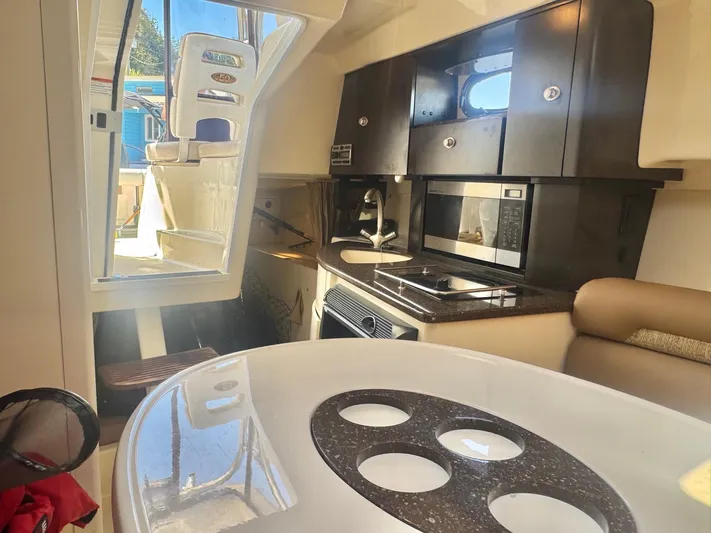  Yacht Photos Pics Interior of 2008 Boston Whaler 285 Conquest, featuring kitchen and seating area.