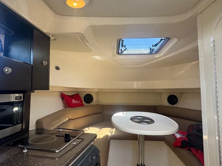  Yacht Photos Pics 2008 Boston Whaler 285 Conquest cabin interior with kitchenette and seating area.