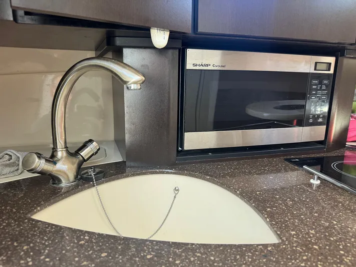  Yacht Photos Pics 2008 Boston Whaler 285 Conquest kitchen with sink and Sharp microwave.