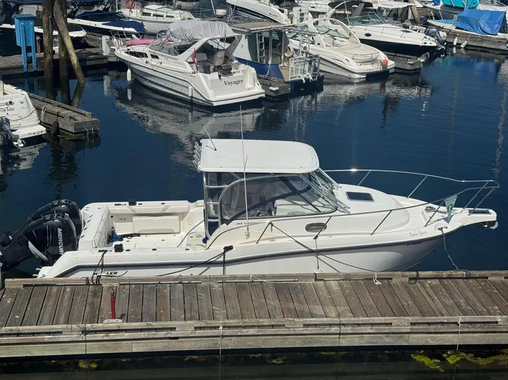  Yacht Photos Pics 2008 Boston Whaler 285 Conquest docked at marina with other boats.
