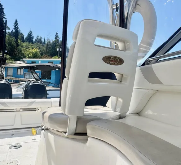  Yacht Photos Pics 2008 Boston Whaler 285 Conquest interior with white seating and scenic marina backdrop.