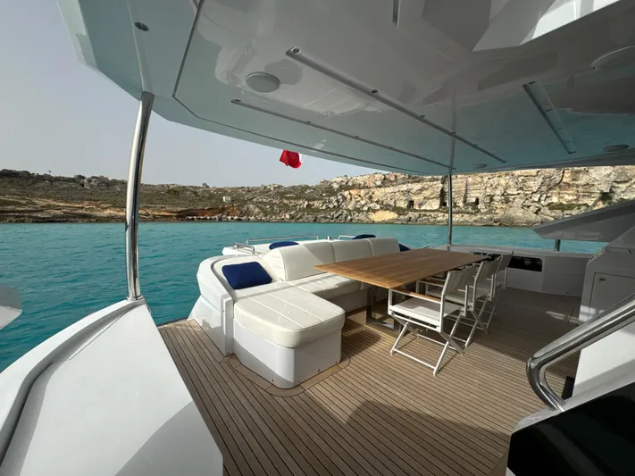 Altvs Yacht Photos Pics Luxurious 2020 PerMare Amer F100 yacht deck with seating, overlooking serene turquoise waters.