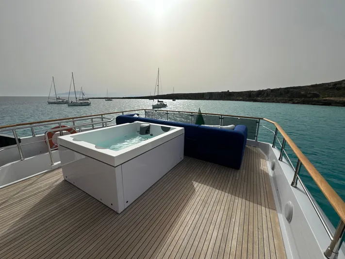 Altvs Yacht Photos Pics Luxurious 2020 PerMare Amer F100 yacht deck with jacuzzi, overlooking serene ocean and sailboats.