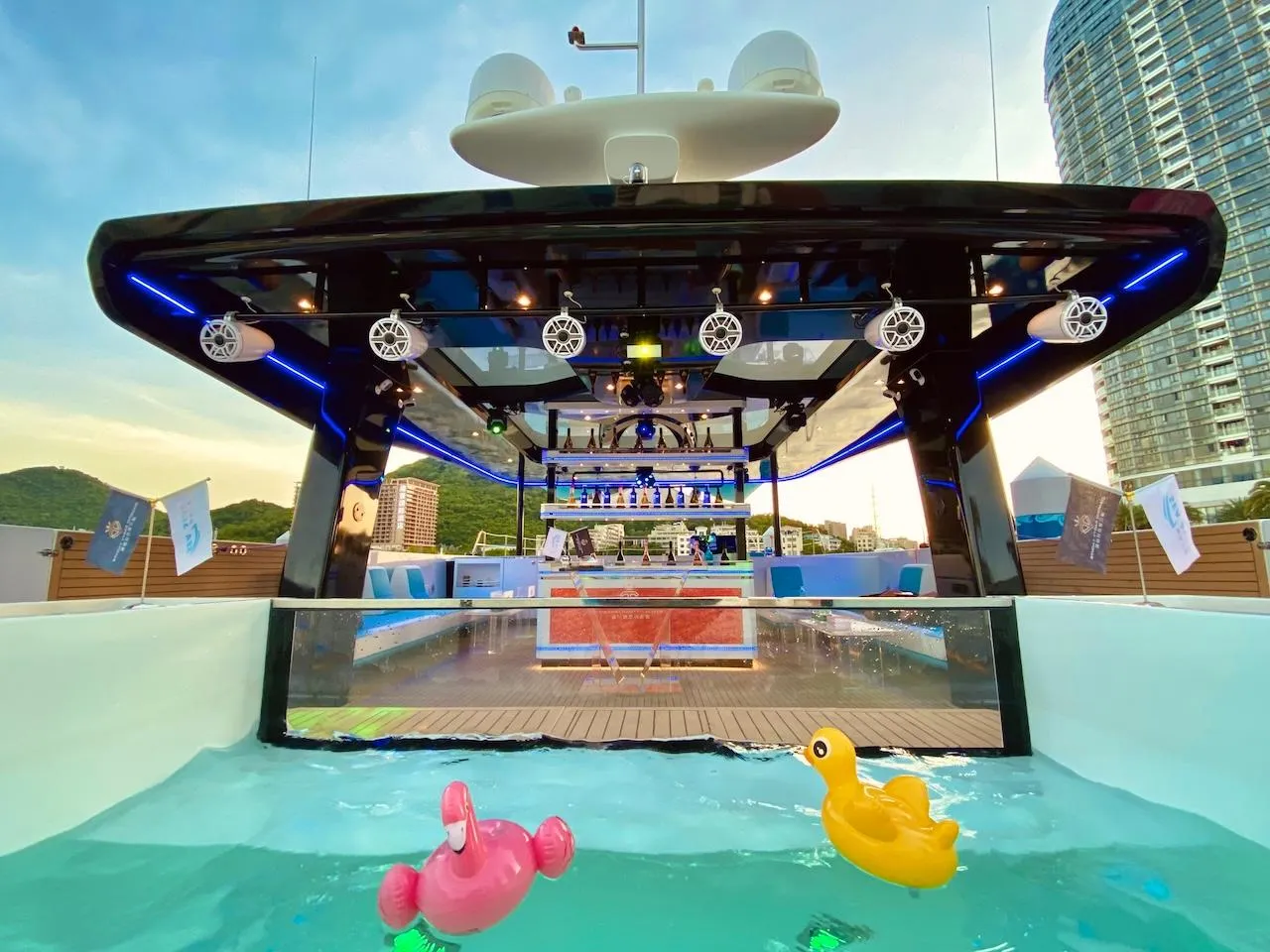 2024 Catamaran Diamond Yachts P55 Power Catamaran with pool and cityscape backdrop.