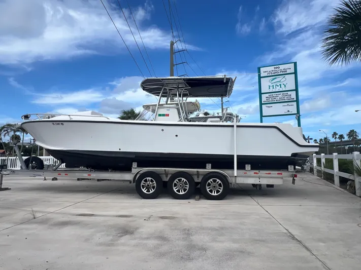  Yacht Photos Pics 2004 SeaVee 32 Cuddy Inboard Diesel boat on a trailer, parked outdoors.