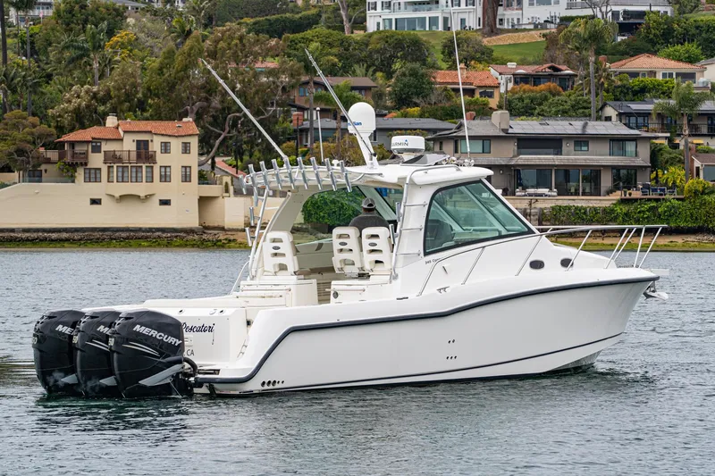 Luna Dei Pescatori Yacht Photos Pics 2009 Boston Whaler 345 Conquest boat on water, with twin Mercury engines, near waterfront homes.