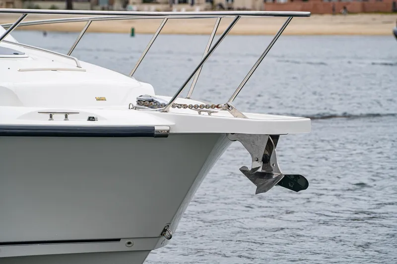 Luna Dei Pescatori Yacht Photos Pics 2009 Boston Whaler 345 Conquest boat bow with anchor, docked on calm water.