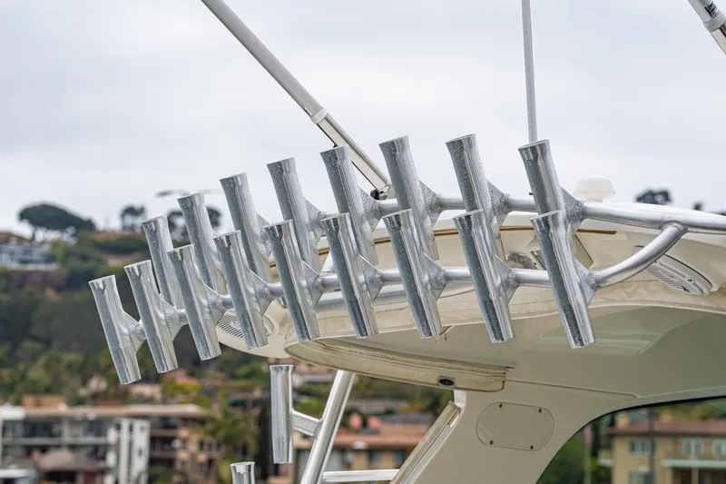 Luna Dei Pescatori Yacht Photos Pics Rod holders on a 2009 Boston Whaler 345 Conquest boat, with a scenic background.