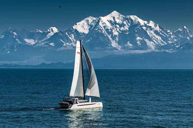  Yacht Photos Pics Sailing HH Catamarans HH55 (2022) with snowy mountains in the background.