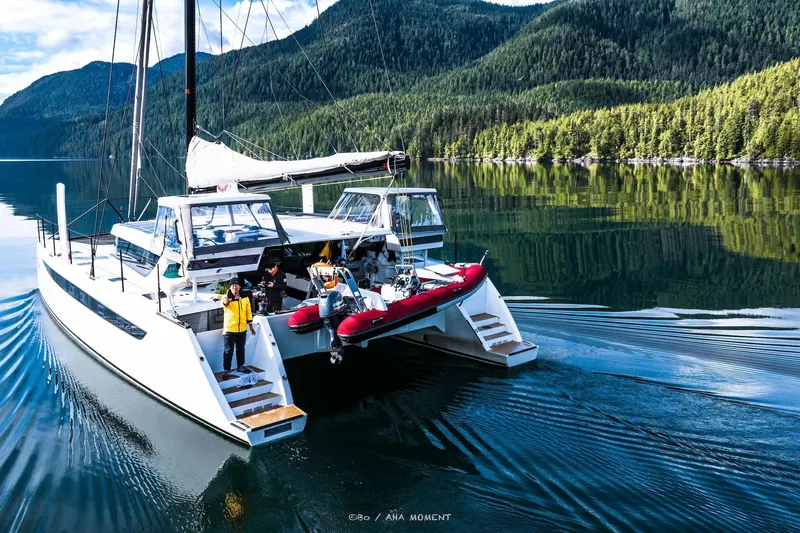  Yacht Photos Pics 2022 HH Catamarans HH55 sailing in serene forested waters.