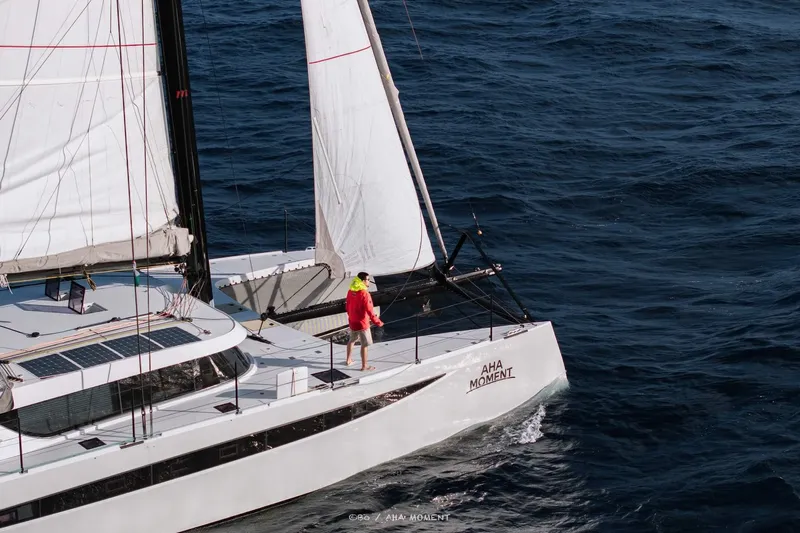 Yacht Photos Pics 2022 HH Catamarans HH55 sailing on open sea with person on deck.