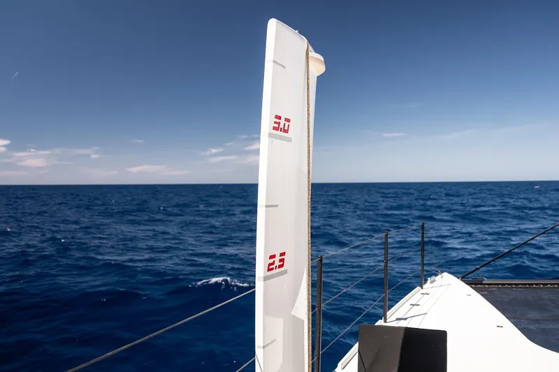  Yacht Photos Pics 2022 HH Catamarans HH55 sailing on open sea under clear blue sky.