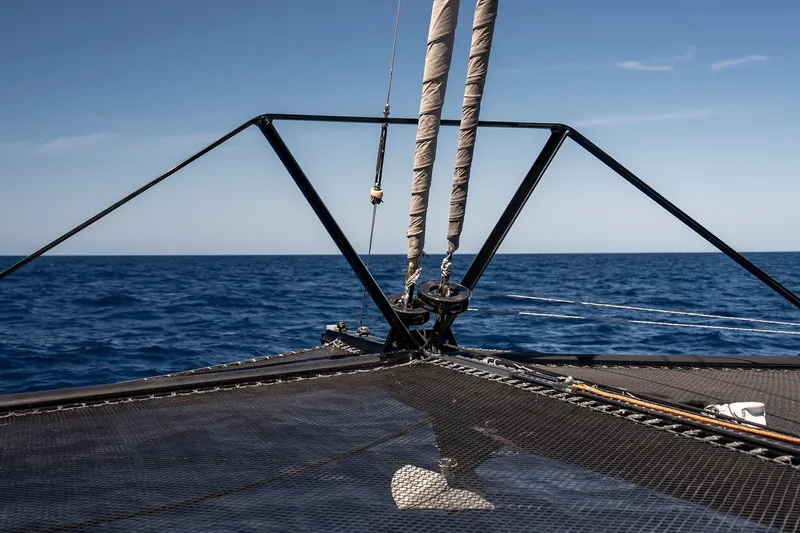  Yacht Photos Pics Bow of 2022 HH Catamarans HH55 sailing on open sea under clear blue sky.