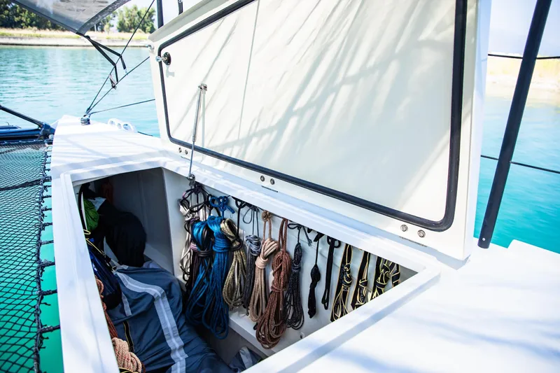  Yacht Photos Pics Storage compartment on 2022 HH Catamarans HH55, featuring organized ropes and gear.