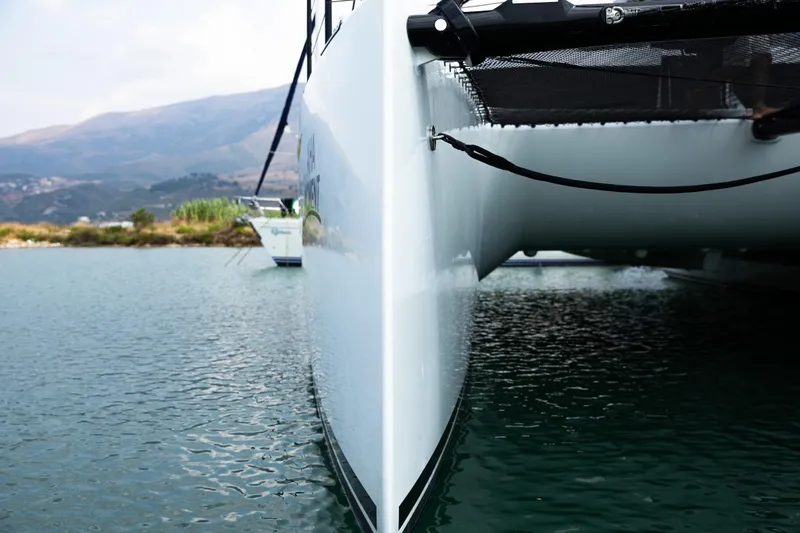  Yacht Photos Pics 2022 HH Catamarans HH55 on water, showcasing sleek hull design.