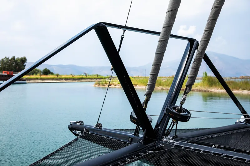  Yacht Photos Pics 2022 HH Catamarans HH55 sailing rigging on calm water with scenic background.