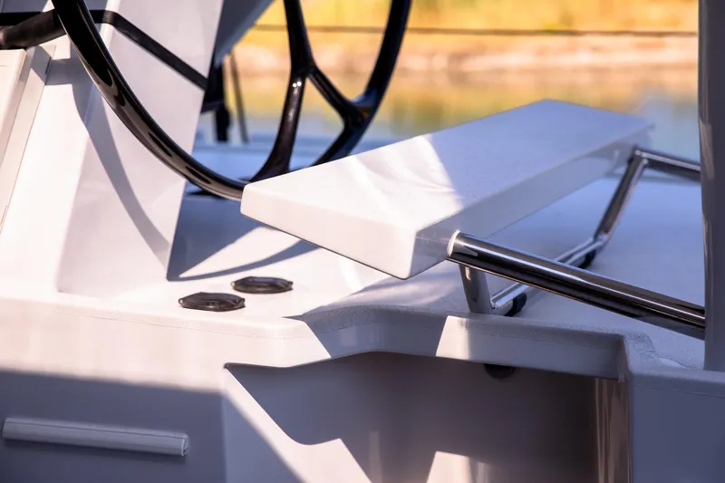  Yacht Photos Pics Close-up of 2022 HH Catamarans HH55 helm station with steering wheel and seating.