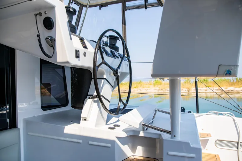  Yacht Photos Pics Helm station of 2022 HH Catamarans HH55, featuring modern controls and steering wheel.