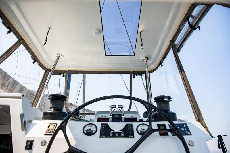 Yacht Photos Pics Cockpit view of 2022 HH Catamarans HH55, featuring steering wheel and navigation instruments.