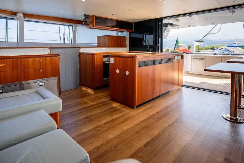  Yacht Photos Pics Luxurious interior of 2022 HH Catamarans HH55 with wooden flooring and modern kitchen.