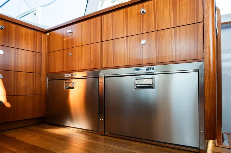  Yacht Photos Pics Luxurious wooden cabinetry and stainless steel appliances in 2022 HH Catamarans HH55 yacht.