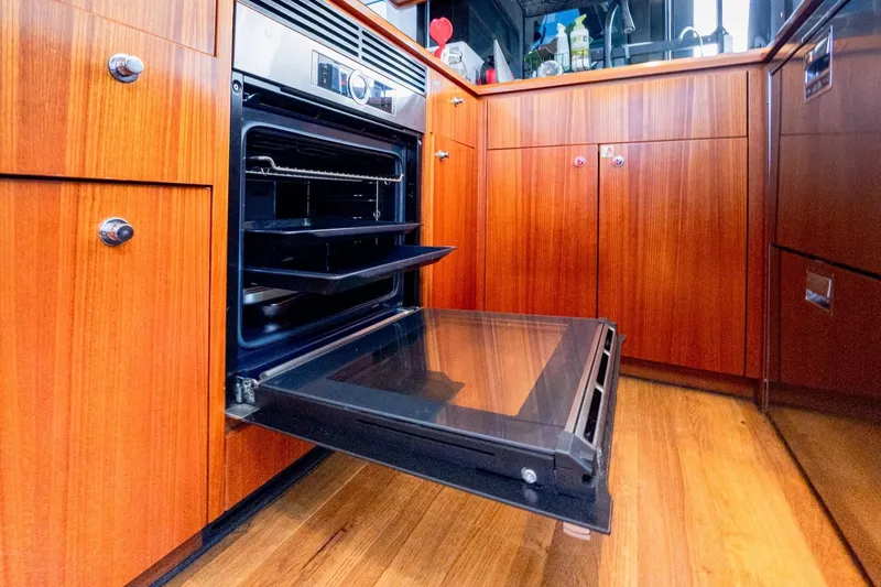  Yacht Photos Pics Open oven in wooden kitchen of 2022 HH Catamarans HH55 yacht.