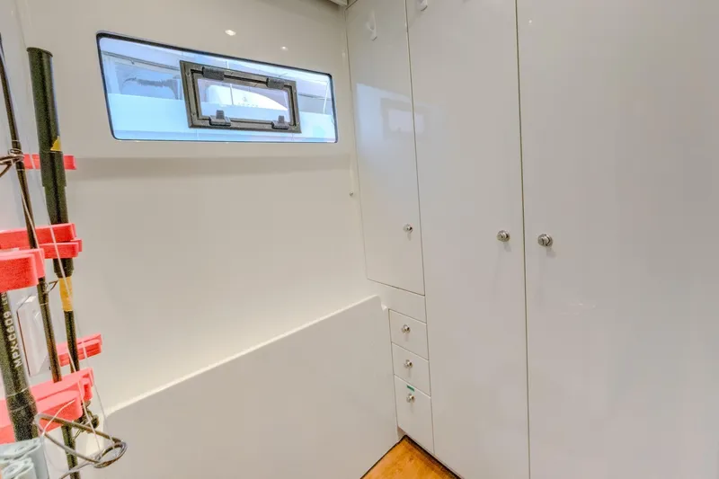  Yacht Photos Pics Interior of 2022 HH Catamarans HH55, featuring sleek white cabinetry and a window.