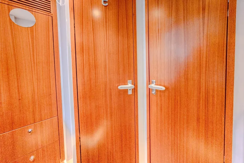  Yacht Photos Pics Interior of 2022 HH Catamarans HH55, featuring sleek wooden doors and modern handles.