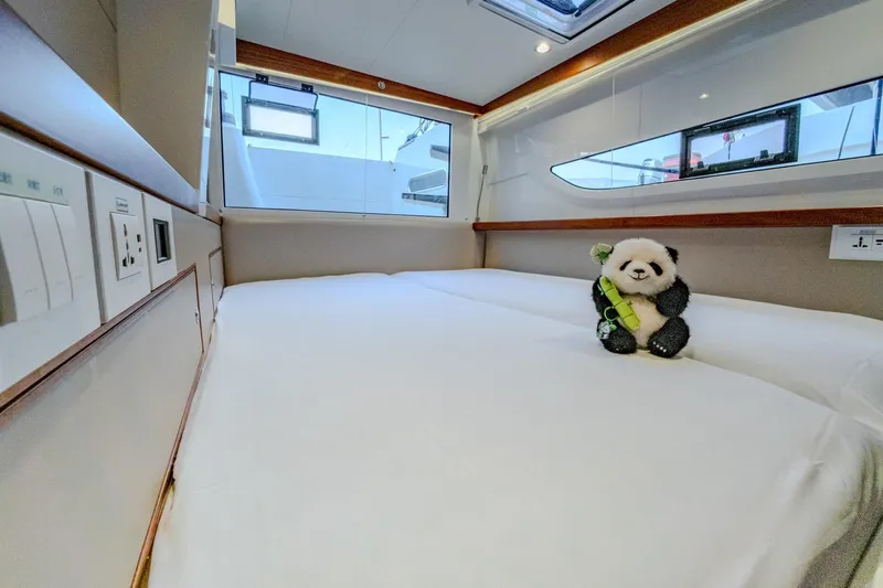  Yacht Photos Pics Luxurious cabin interior of 2022 HH Catamarans HH55 with plush bedding and panda toy.