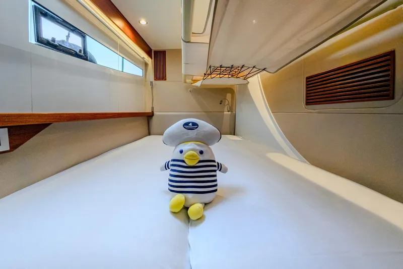  Yacht Photos Pics Stuffed sailor duck on bed in 2022 HH Catamarans HH55 cabin interior.