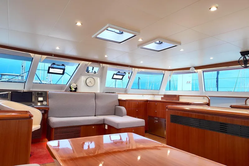  Yacht Photos Pics Luxurious interior of 2022 HH Catamarans HH55 with modern furnishings and panoramic windows.