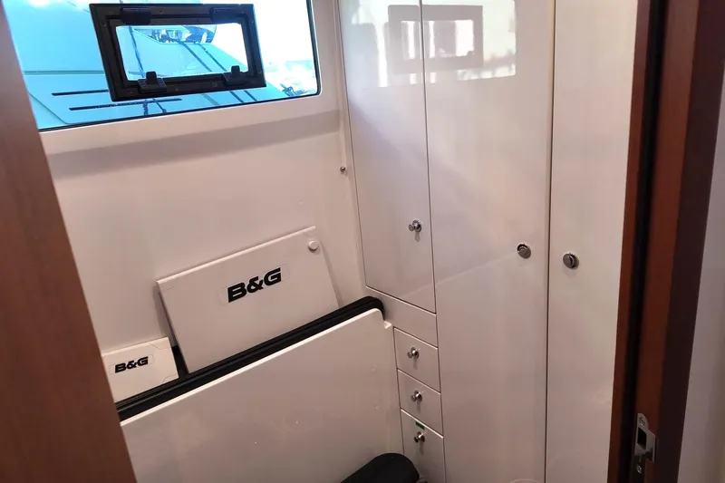  Yacht Photos Pics Interior of 2022 HH Catamarans HH55, featuring storage cabinets and B&G equipment.