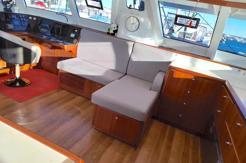  Yacht Photos Pics Interior of 2022 HH Catamarans HH55, featuring modern helm and cozy seating area.