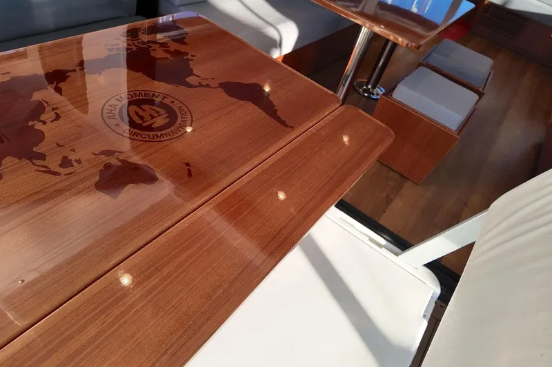  Yacht Photos Pics Luxurious interior of 2022 HH Catamarans HH55 with elegant wooden table design.