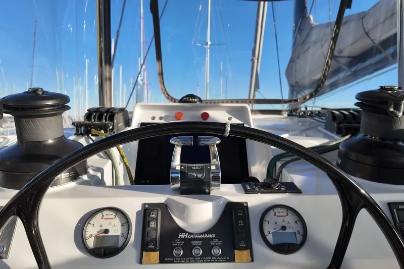  Yacht Photos Pics Cockpit view of 2022 HH Catamarans HH55, featuring steering wheel and control panel.