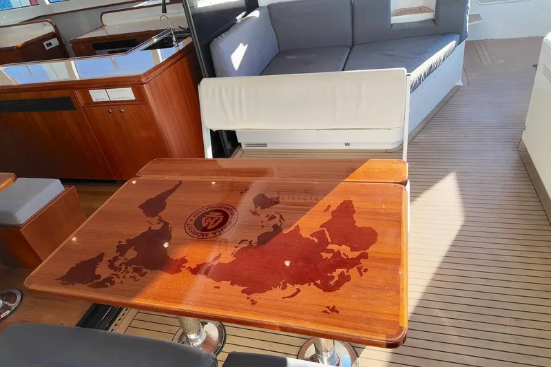  Yacht Photos Pics Luxurious interior of 2022 HH Catamarans HH55 with elegant wood finishes and modern seating.