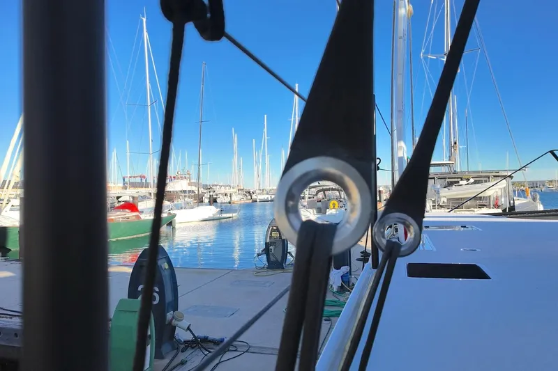  Yacht Photos Pics 2022 HH Catamarans HH55 docked at marina, surrounded by sailboats under clear blue sky.