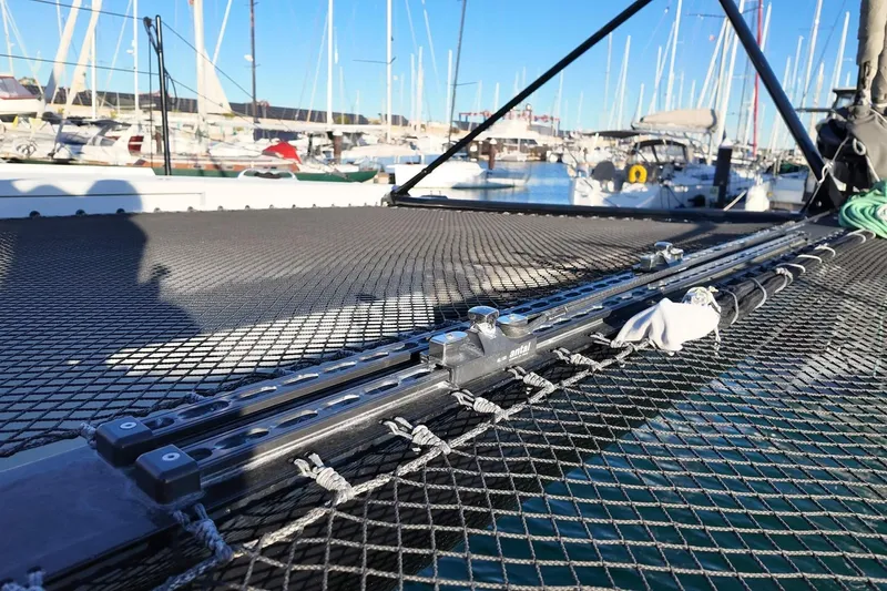  Yacht Photos Pics 2022 HH Catamarans HH55 deck with netting and marina background.