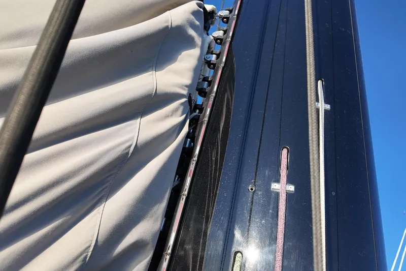  Yacht Photos Pics Close-up of 2022 HH55 Catamaran mast and sail details against blue sky.