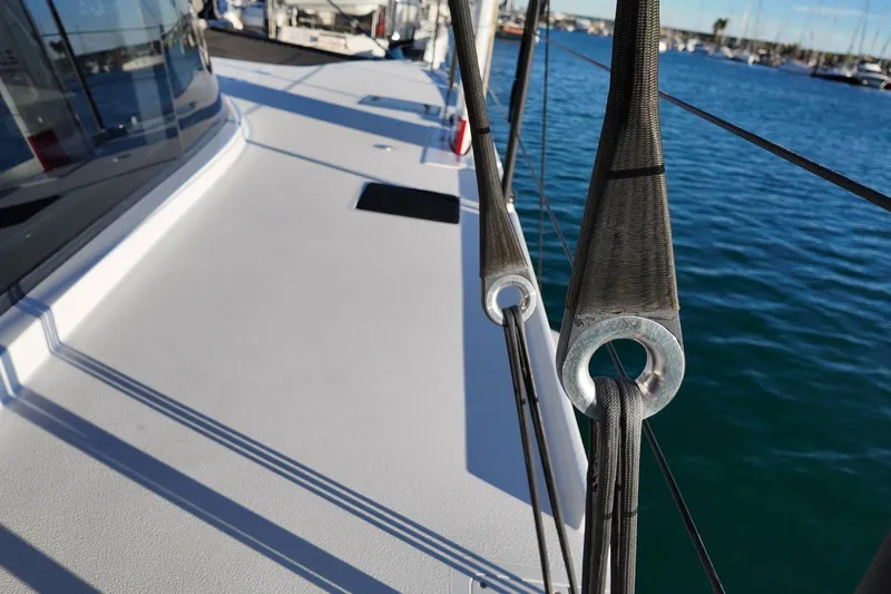  Yacht Photos Pics 2022 HH Catamarans HH55 deck with rigging, overlooking marina waters.