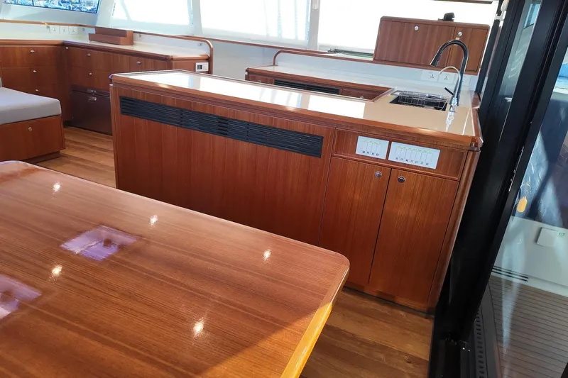  Yacht Photos Pics Luxurious interior of 2022 HH Catamarans HH55 with elegant wood finish and modern amenities.