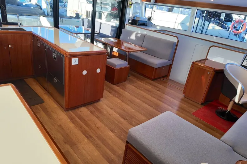  Yacht Photos Pics Interior of 2022 HH Catamarans HH55, featuring modern wood finish and seating area.
