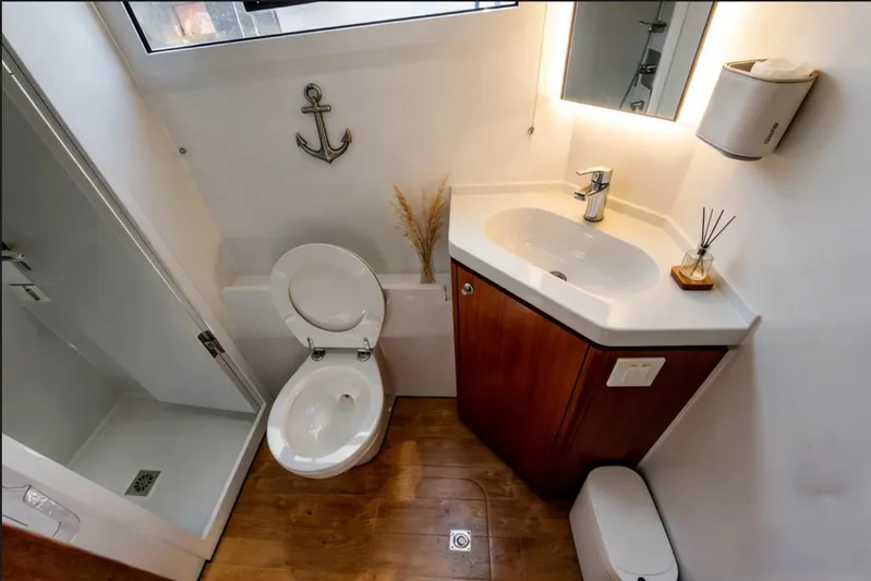  Yacht Photos Pics Luxurious bathroom in 2022 HH Catamarans HH55, featuring modern fixtures and nautical decor.