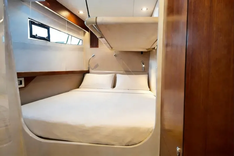  Yacht Photos Pics Luxurious cabin interior of 2022 HH Catamarans HH55 with cozy bed and modern lighting.