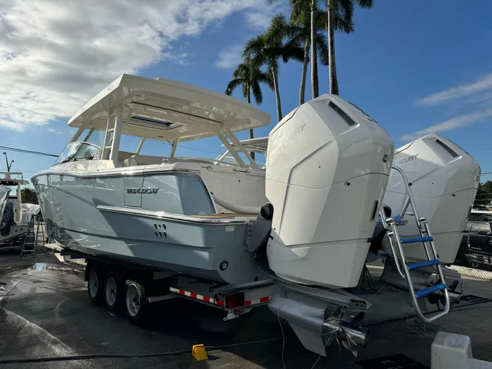 Pcm 51799 400dcis Yacht Photos Pics 2025 World Cat 400 DC-IS boat on trailer with twin engines, under palm trees.