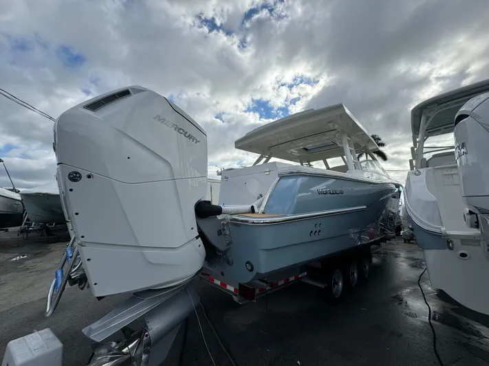 Pcm 51799 400dcis Yacht Photos Pics 2025 World Cat 400 DC-IS boat with Mercury outboard engines, docked under cloudy skies.